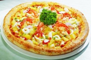 The seafood gulai pizza is a wonderful fusion of Asian and Italian flavours with toppings of succulent prawn and squid in a curry sauce base.